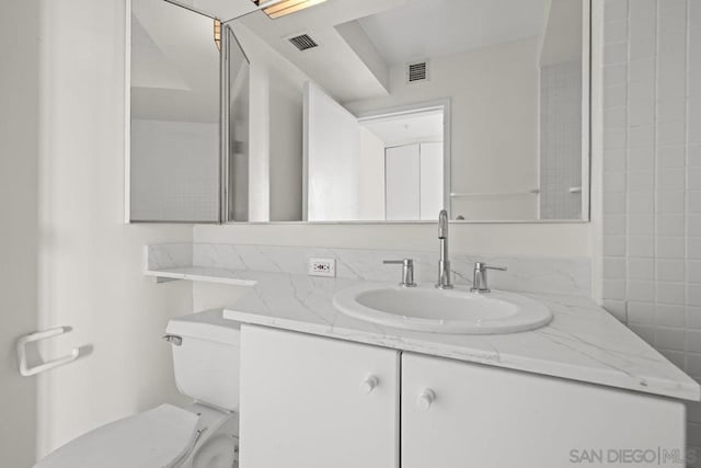 bathroom with toilet and vanity