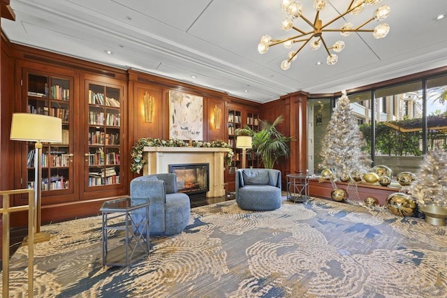 sitting room featuring a chandelier and ornamental molding