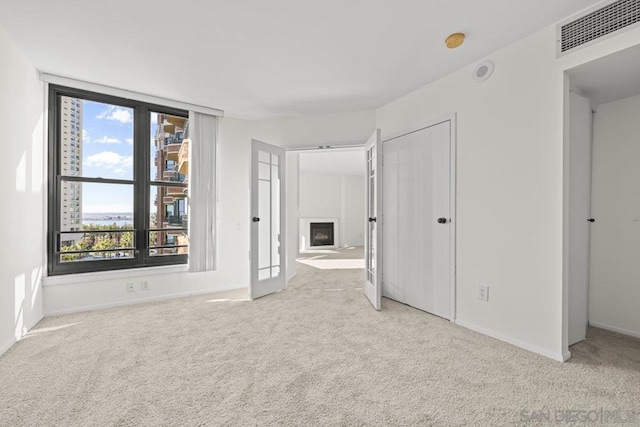 unfurnished room with light colored carpet