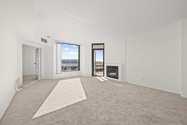 unfurnished living room featuring light colored carpet