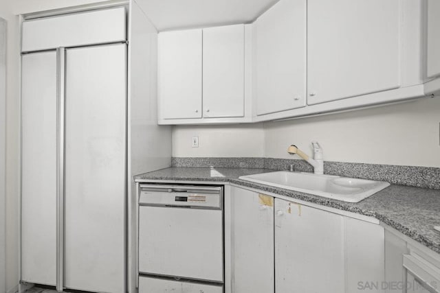 kitchen with white cabinetry, white dishwasher, paneled built in fridge, and sink