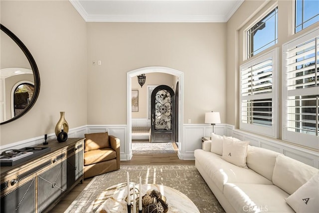 living room with dark wood-type flooring and crown molding