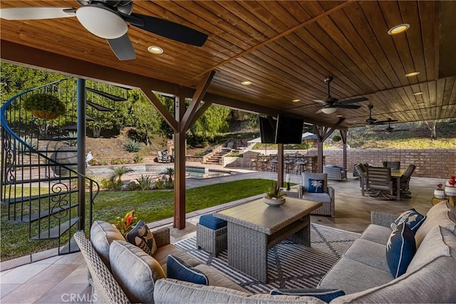 view of patio / terrace with an outdoor living space and ceiling fan