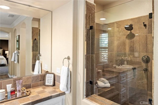 bathroom featuring an enclosed shower and crown molding