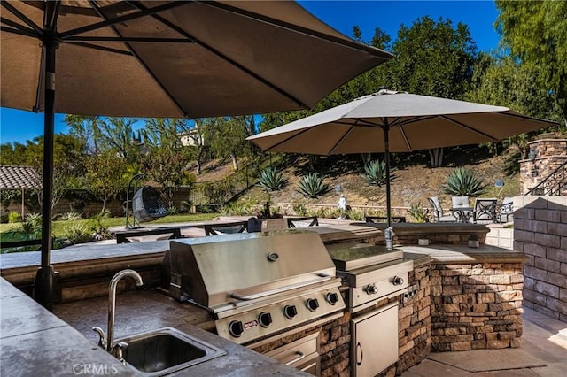 view of patio / terrace featuring exterior kitchen, sink, and grilling area