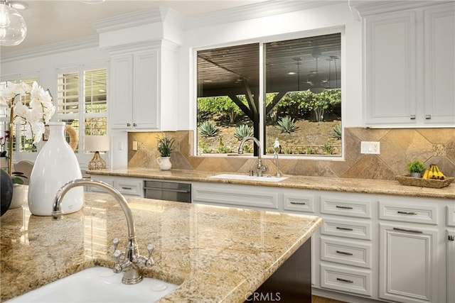 kitchen featuring white cabinets, tasteful backsplash, and sink