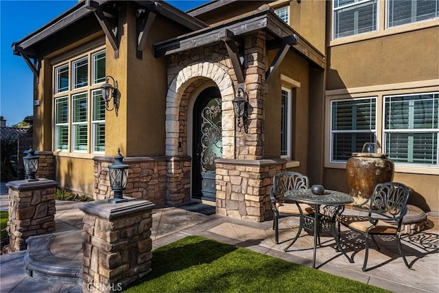 entrance to property featuring a patio