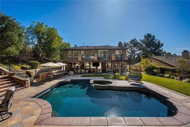 view of swimming pool with an in ground hot tub, a patio area, and a bar