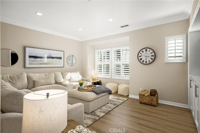 living room with crown molding and hardwood / wood-style flooring