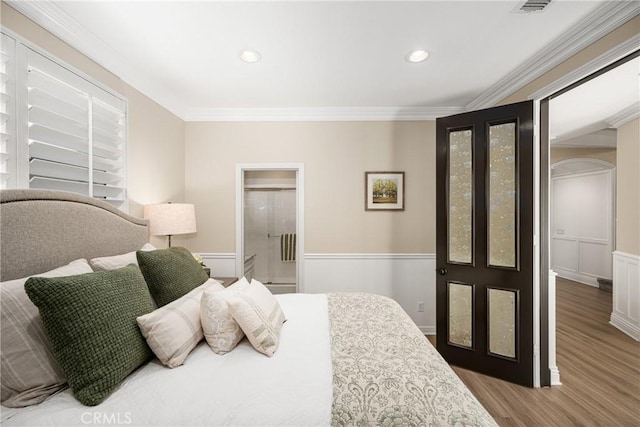 bedroom featuring ornamental molding and hardwood / wood-style floors