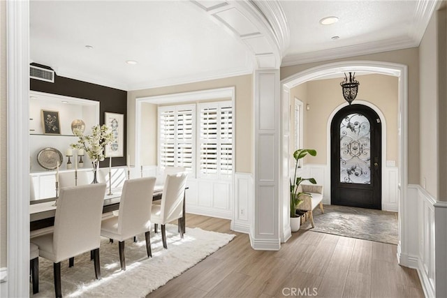 entrance foyer featuring light hardwood / wood-style flooring and crown molding