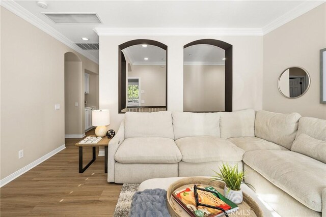 living room with crown molding and hardwood / wood-style floors