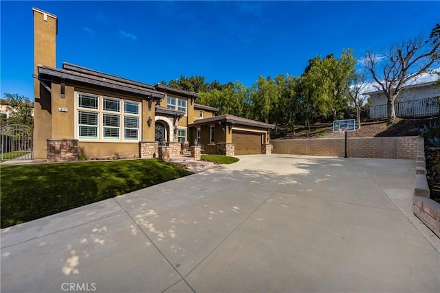 view of front of property featuring a front yard and a garage