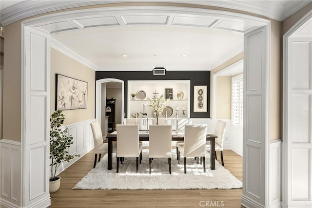 dining space featuring hardwood / wood-style flooring and ornamental molding