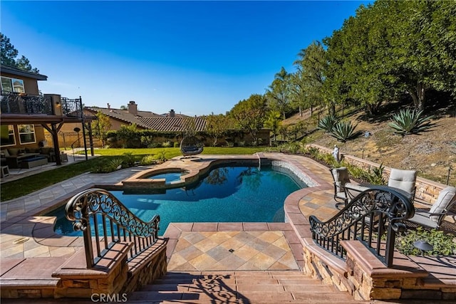 view of pool with an in ground hot tub and a patio