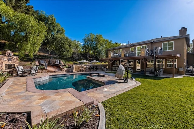 view of pool with a patio area, an outdoor stone fireplace, an in ground hot tub, and a lawn