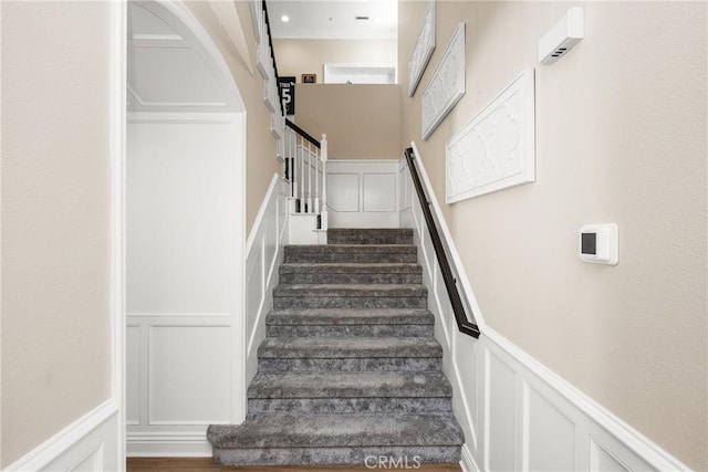 staircase featuring ornamental molding