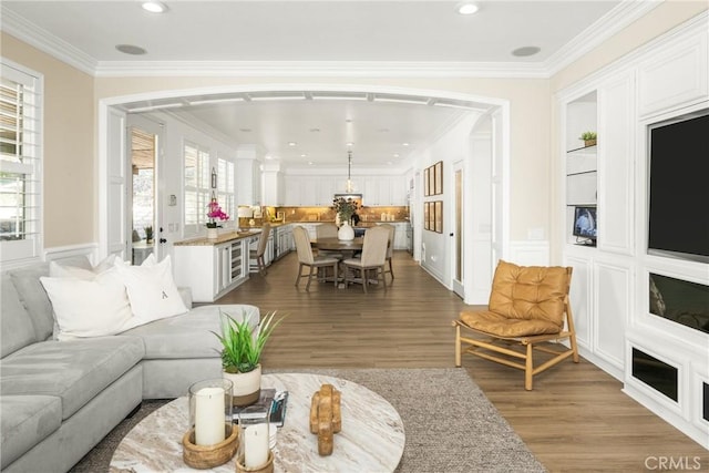 living room featuring crown molding and hardwood / wood-style flooring