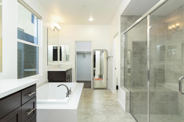 bathroom with tile patterned flooring, vanity, and plus walk in shower