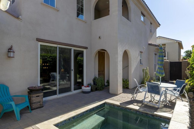 view of pool with a jacuzzi and a patio area