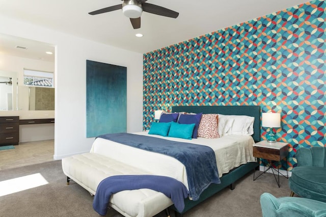 carpeted bedroom with ceiling fan and connected bathroom