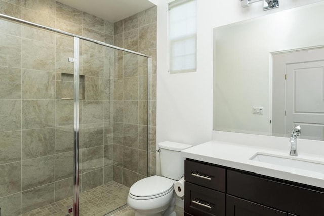 bathroom with toilet, walk in shower, and vanity