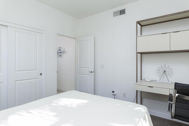 bedroom with dark colored carpet