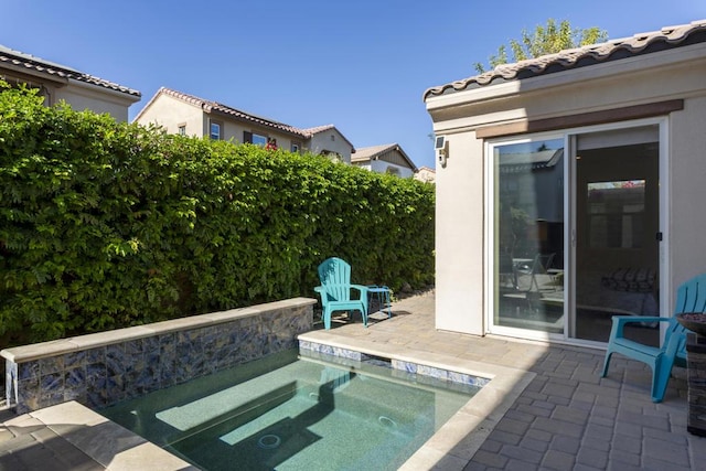 view of pool with an in ground hot tub