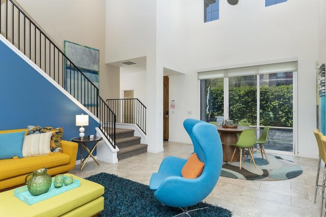 living room featuring a towering ceiling