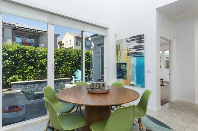 dining space featuring light tile patterned floors