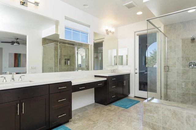 bathroom featuring ceiling fan, vanity, and an enclosed shower