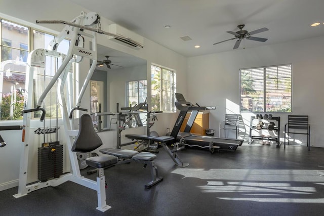 gym with ceiling fan and a wall mounted AC