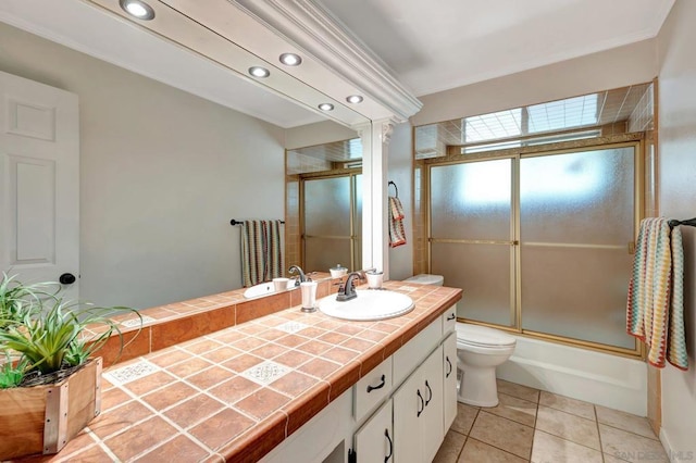 full bathroom with enclosed tub / shower combo, vanity, toilet, and tile patterned flooring