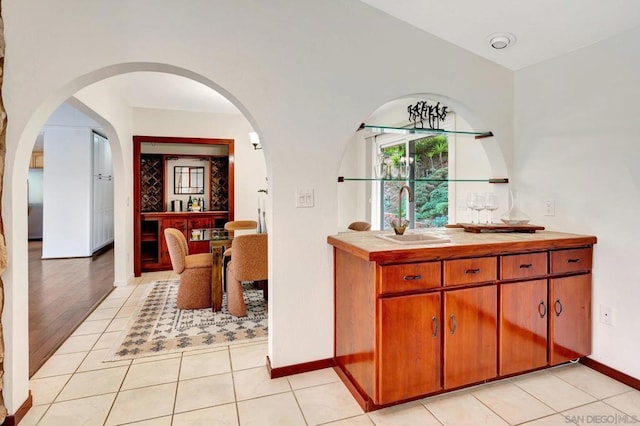 interior space with light tile patterned floors and sink