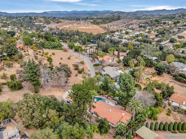 birds eye view of property featuring a mountain view