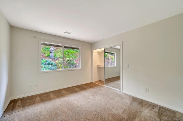 carpeted empty room featuring a healthy amount of sunlight