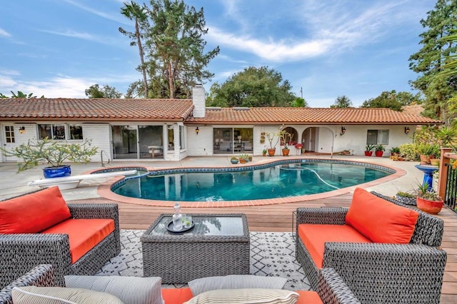 view of swimming pool featuring an in ground hot tub, outdoor lounge area, and a patio area