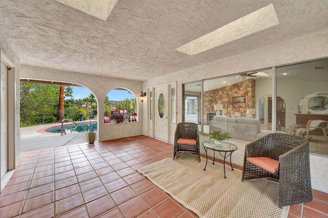 unfurnished sunroom with a skylight