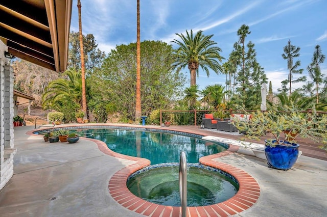 view of pool featuring a patio area, outdoor lounge area, and an in ground hot tub