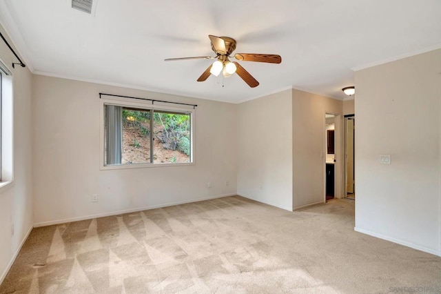 empty room with light carpet, ceiling fan, and ornamental molding