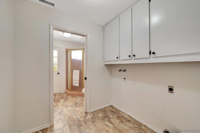 laundry room with washer hookup, electric dryer hookup, and cabinets