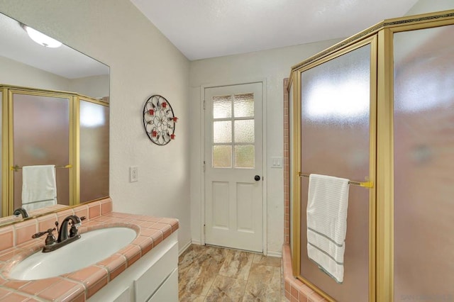 bathroom with an enclosed shower and vanity