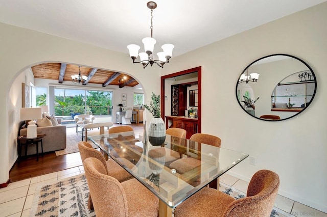 dining space featuring a notable chandelier, wooden ceiling, tile patterned flooring, and beamed ceiling