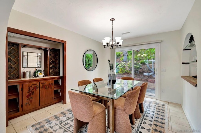 dining space with a notable chandelier and light tile patterned flooring