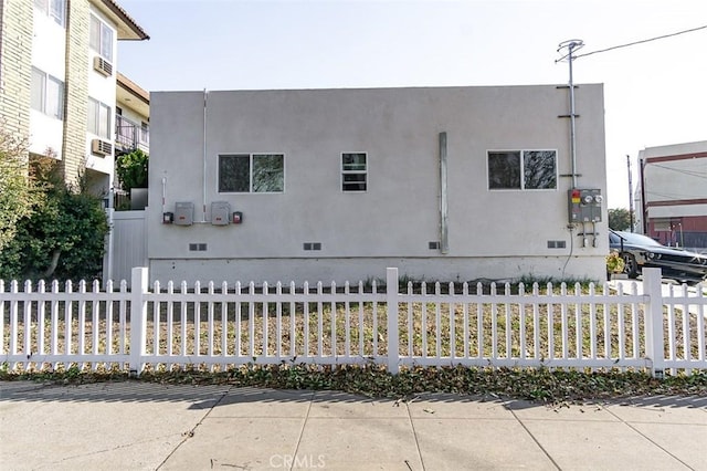 view of front of home featuring crawl space and fence
