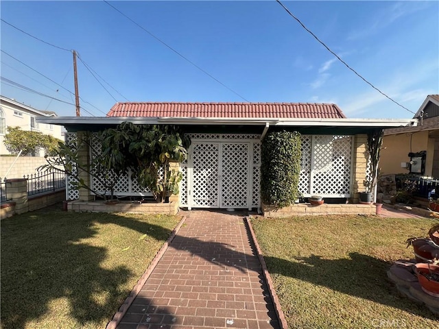 rear view of house featuring a lawn