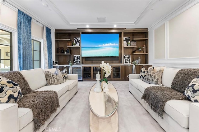 living room featuring crown molding, built in features, and a raised ceiling