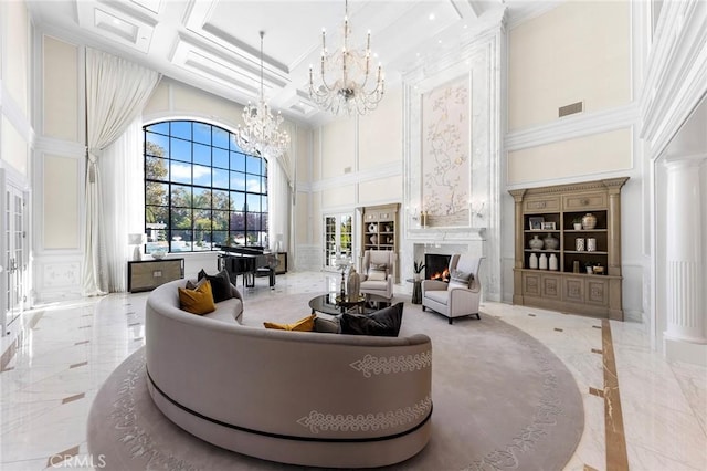 living room with beamed ceiling, a high ceiling, coffered ceiling, ornamental molding, and ornate columns