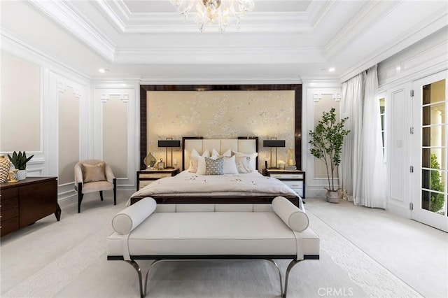 carpeted bedroom featuring an inviting chandelier, crown molding, and a tray ceiling