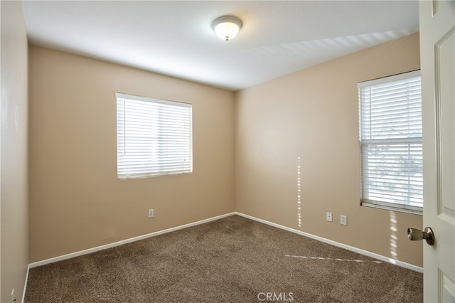 carpeted empty room featuring plenty of natural light